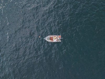 Grey boat floating on the surface of the ocean during the day
